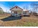 Quaint home showcasing a covered porch, red shutters, and a fenced yard at 5700 Mount Zion Rd, Waco, GA 30182