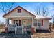 Inviting white home featuring a cozy porch, red shutters, and string lights at 5700 Mount Zion Rd, Waco, GA 30182
