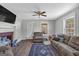 Cozy living room with wood floors, fireplace, and large windows, creating a warm and inviting atmosphere at 5700 Mount Zion Rd, Waco, GA 30182