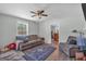 Bright living room with hardwood floors, comfortable seating, and large window, ideal for relaxing and entertaining at 5700 Mount Zion Rd, Waco, GA 30182