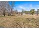 Scenic view of a large, grassy yard leading up to a charming house with a covered porch and separate garage at 5700 Mount Zion Rd, Waco, GA 30182