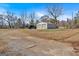 Spacious yard leading to a detached garage, offering a large outdoor area with privacy and potential at 5700 Mount Zion Rd, Waco, GA 30182