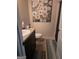 A cozy bathroom featuring a granite-topped vanity and a decorative floral painting at 620 Calvo Run, Mcdonough, GA 30253