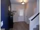 Bright entryway with neutral walls, dark blue accent wall and light wood-look flooring at 620 Calvo Run, Mcdonough, GA 30253