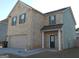Two-story brick home featuring an attached garage and dark green shutters at 620 Calvo Run, Mcdonough, GA 30253