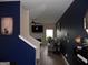 View from stairs into the living room featuring a fireplace and hardwood flooring at 620 Calvo Run, Mcdonough, GA 30253