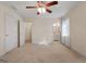 Large primary bedroom with carpeted floors, neutral walls, ceiling fan, and doors to the closet and bathroom at 340 Antebellum Way, Fayetteville, GA 30215