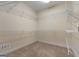 Walk-in closet with carpeted floors and white wire shelving along the walls at 340 Antebellum Way, Fayetteville, GA 30215