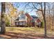 Stunning front exterior of brick home with decorative shutters, gabled roof, and manicured lawn at 340 Antebellum Way, Fayetteville, GA 30215