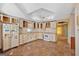 Kitchen featuring dated appliances, cabinetry, tile floors and open view to other areas of the home at 125 Kennedy Estate Rd, Carrollton, GA 30116