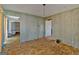 Spacious living room with wood paneled walls, patterned ceiling, and bright windows at 125 Kennedy Estate Rd, Carrollton, GA 30116