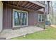 Back patio featuring sliding glass doors, lawn and exterior AC unit at 26 Cobblestone Creek, Peachtree City, GA 30269