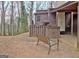 Cozy backyard with a wooden bench and well-maintained lawn at 26 Cobblestone Creek, Peachtree City, GA 30269