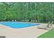 Community pool featuring clear blue water, green trees and lots of chairs at 26 Cobblestone Crk, Peachtree City, GA 30269