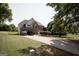 Brick two-story home featuring a long driveway and mature landscaping at 424 Norman Ct, Hampton, GA 30228