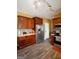 Well-equipped kitchen featuring wood cabinets, stainless steel appliances, and durable laminate flooring at 424 Norman Ct, Hampton, GA 30228