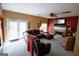 Relaxing living room featuring a leather sofa, fireplace, television, and access to the backyard at 424 Norman Ct, Hampton, GA 30228
