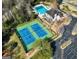 An aerial view of the tennis court, pool, and building at Wood Creek Community in a wooded setting at 407 Holly Grove Church Rd, Peachtree City, GA 30269