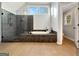 Bathroom with a glass-enclosed shower, soaking tub and ceramic tile floors at 407 Holly Grove Church Rd, Peachtree City, GA 30269