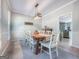 Well-lit dining room with a rustic wooden table and seating for eight, perfect for gatherings at 407 Holly Grove Church Rd, Peachtree City, GA 30269