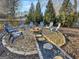Cozy backyard fire pit with stone surround and seating, perfect for outdoor gatherings at 407 Holly Grove Church Rd, Peachtree City, GA 30269