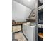 Efficient laundry room featuring modern washer and dryer, open shelving, and rustic decor at 407 Holly Grove Church Rd, Peachtree City, GA 30269