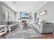 Bright living room with custom built-ins, a fireplace, comfortable sofas, and a stylish area rug at 407 Holly Grove Church Rd, Peachtree City, GA 30269