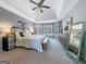 Spacious main bedroom with a tray ceiling, many windows and neutral décor at 407 Holly Grove Church Rd, Peachtree City, GA 30269