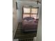 View of cozy bedroom with twin bed and dark rug at 79 Flint River Rd, Riverdale, GA 30274