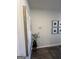 Hallway featuring wood-look floors, wall art, and plant, enhancing the modern decor and homey atmosphere at 11569 Kimberly Way # 26, Hampton, GA 30228