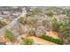 Aerial view showcasing the property, surrounding trees, and the road nearby at 1115 Highway 54 East, Fayetteville, GA 30214