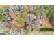 Overhead view of the property showing the house, outbuildings, and wooded surroundings at 1115 Highway 54 East, Fayetteville, GA 30214
