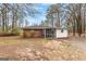 Backyard view of a brick home with a screened in porch and detached garage at 1115 Highway 54 East, Fayetteville, GA 30214