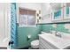 Classic bathroom featuring aqua tile, a vanity with ample storage, and natural light at 1115 Highway 54 East, Fayetteville, GA 30214