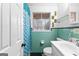 Bathroom featuring vintage turquoise tile, window and coordinating shower curtain at 1115 Highway 54 East, Fayetteville, GA 30214