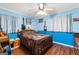 Bedroom with blue walls, ceiling fan, decor, and lots of natural light streaming in at 1115 Highway 54 East, Fayetteville, GA 30214