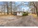 Detached garage with gravel driveway and screened in porch at 1115 Highway 54 East, Fayetteville, GA 30214
