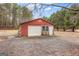 Detached garage with a roll-up door, side door, and window, providing ample storage or workspace at 1115 Highway 54 East, Fayetteville, GA 30214