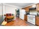 Classic kitchen featuring wooden floors, white appliances, and a view into the cozy living room at 1115 Highway 54 East, Fayetteville, GA 30214