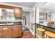 Kitchen view through door that leads to back mudroom, featuring a breakfast bar and sleek countertops at 1115 Highway 54 East, Fayetteville, GA 30214