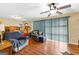 Comfortable living room with plenty of seating, a ceiling fan, and large window with vertical blinds at 1115 Highway 54 East, Fayetteville, GA 30214