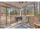 Inviting screened porch featuring outdoor seating, a grill, and views of the surrounding lush greenery at 1115 Highway 54 East, Fayetteville, GA 30214