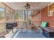 Comfortable screened-in porch with furniture, a grill, and views of the backyard greenery, perfect for relaxation at 1115 Highway 54 East, Fayetteville, GA 30214