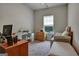 Well-lit bedroom furnished with a large desk, wooden drawers and a comfortable sofa bed at 9068 Jim Purcell Dr, Covington, GA 30014
