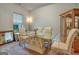 Well-lit dining room with a glass table, neutral-toned chairs, wooden floors, and a cabinet, creating a welcoming atmosphere at 9068 Jim Purcell Dr, Covington, GA 30014