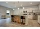 Modern eat-in kitchen featuring stainless steel appliances, granite countertops, stylish lighting, and a breakfast bar with seating at 9068 Jim Purcell Dr, Covington, GA 30014