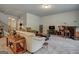 Cozy living room featuring neutral-toned furniture, a bar area, plush carpeting, and ample natural light creating a comfortable space at 9068 Jim Purcell Dr, Covington, GA 30014