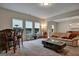 Cozy living room featuring neutral-toned furniture, a bar area, plush carpeting, and ample natural light creating a comfortable space at 9068 Jim Purcell Dr, Covington, GA 30014
