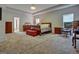 Spacious main bedroom featuring neutral carpet, ample space, and natural light from two windows at 9068 Jim Purcell Dr, Covington, GA 30014