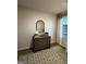 Cozy bedroom showcasing a rustic dresser, round mirror, and patterned rug at 247 Ivey Ter # 45, Temple, GA 30179